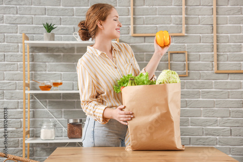 Young woman with paper bag ...