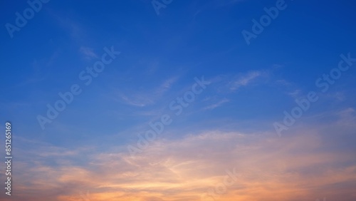 Wallpaper Mural A serene sunset with a gradient sky transitioning from deep blue at the top to warm orange and yellow hues near the horizon. Wispy clouds add texture to the peaceful scene. Cloud background.
 Torontodigital.ca