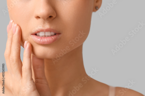 Young woman with hand near ...