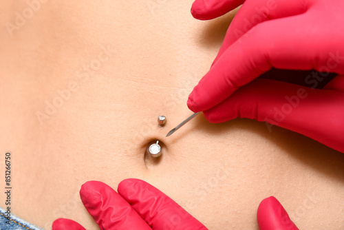Professional doing piercing...