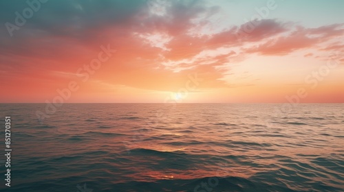 serene sunset over the ocean, with the sky reflecting the soft hues of the setting sun, creating a tranquil and peaceful atmosphere