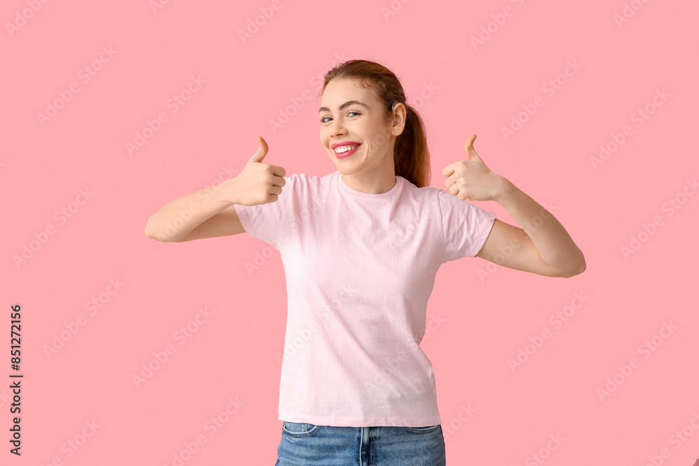 Beautiful young woman with hearing aid showing thumb-up gesture on pink background Beautiful young woman with hearing aid showing thumb-up gesture on pink background