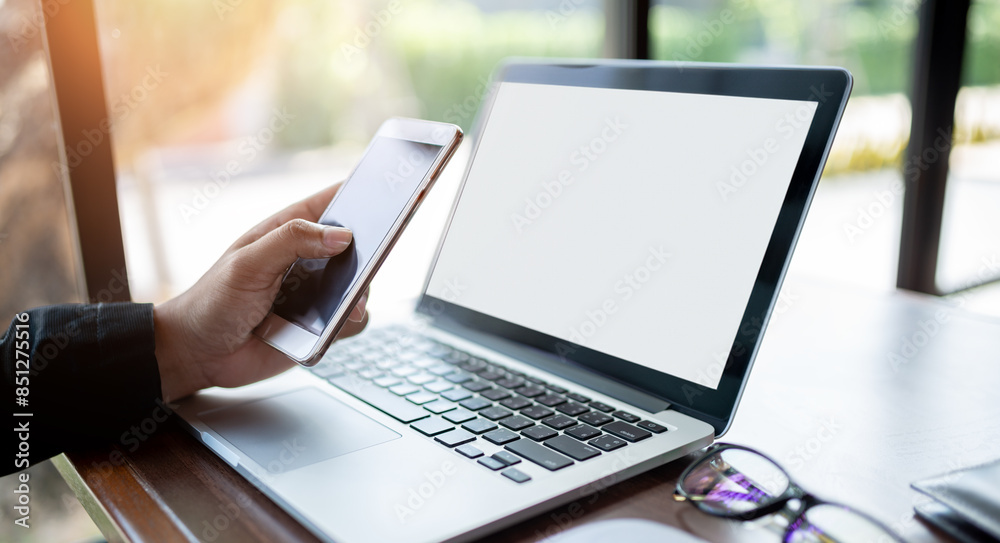 Trader use laptops connected to the internet from smartphones to trade stocks through Wi-Fi hotspot network technology. Business Technology Trader use laptops connected to the internet from smartphones to trade stocks through Wi-Fi hotspot network technology. Business Technology