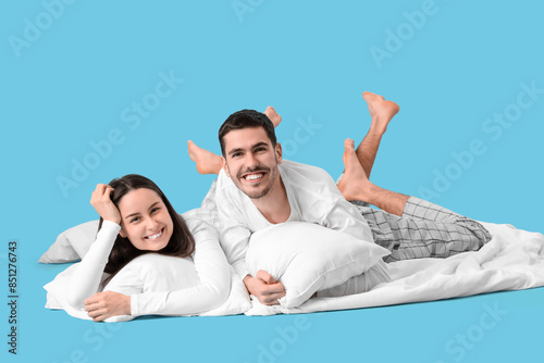 Young couple with pillows l...