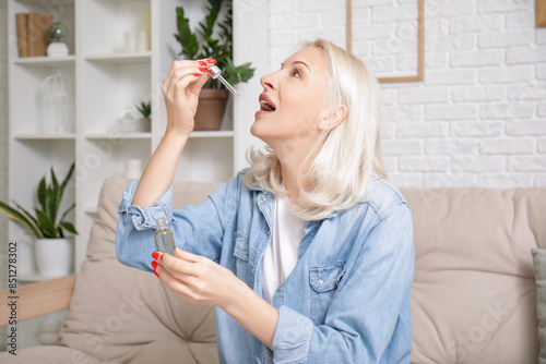 Mature woman taking CBD oil...