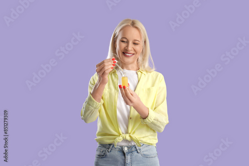 Mature woman with bottle of...