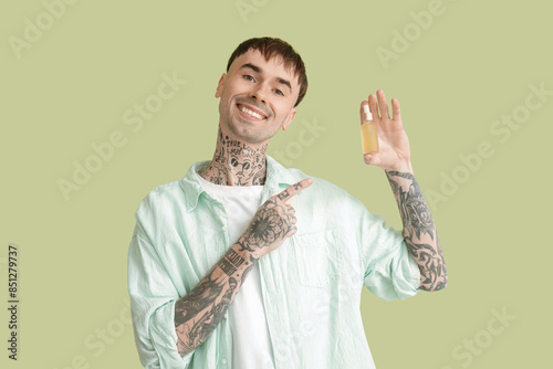 Young tattooed man pointing...