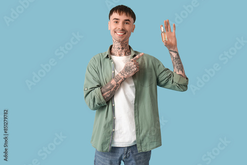 Young tattooed man pointing...