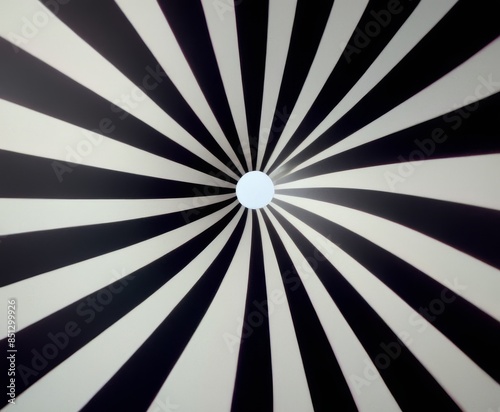 Hypnotic black and white radial pattern creating an optical illusion effect, with converging lines meeting at a central point, perfect for modern art and design projects.. AI Generation