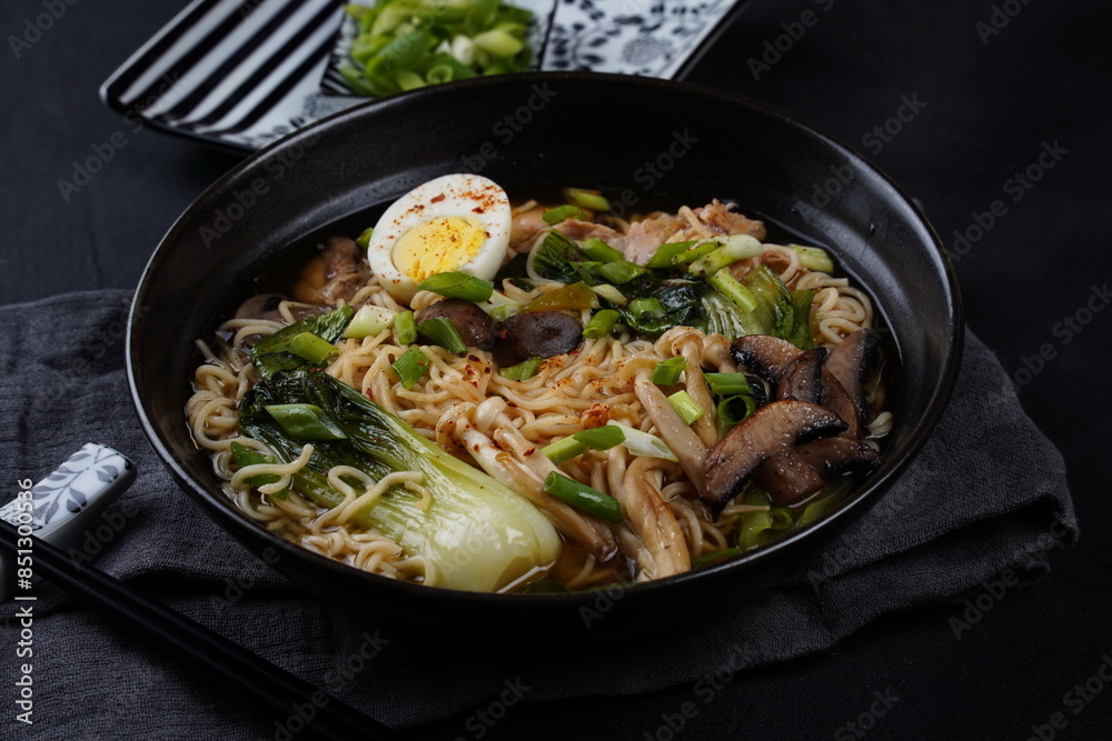 Japanese Ramen with chicken, Mushrooms, Eggs and bok choy cabbage in a bowl Japanese Ramen with chicken, Mushrooms, Eggs and bok choy cabbage in a bowl