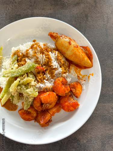 Malaysian styled complete meal for lunch or dinner called Nasi Campur.  It is plain white rice served with variety of dishes. photo