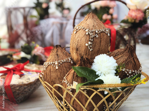 decorated coconut and mango leaves with floral decoration essential in Hindu puja as a part of wedding Trousseau photo