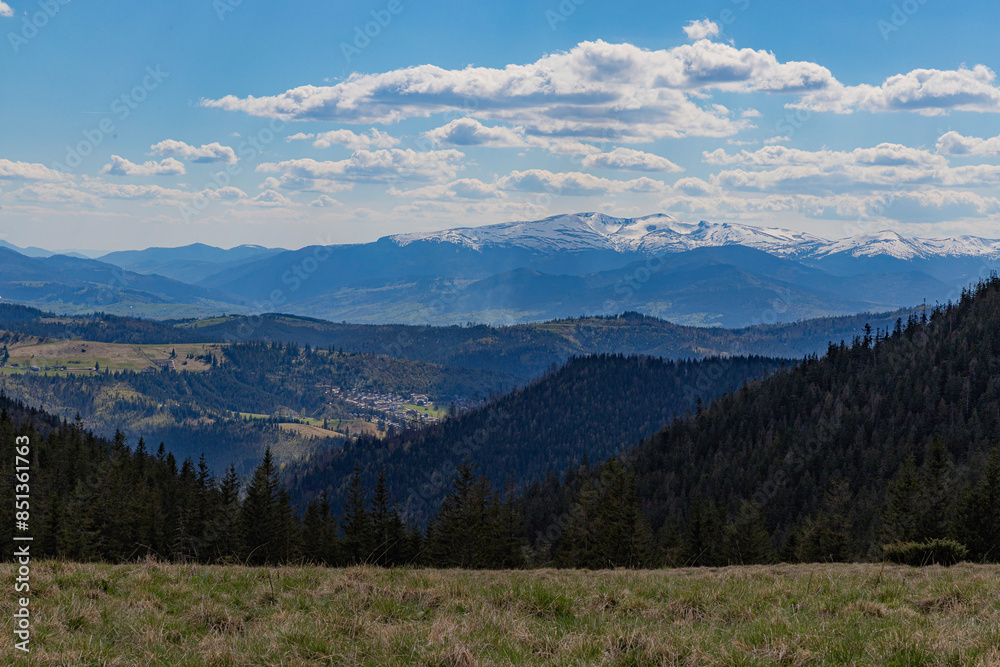 landscape from the mountain meadow. snow-covered mountains and the sky with clouds landscape from the mountain meadow. snow-covered mountains and the sky with clouds