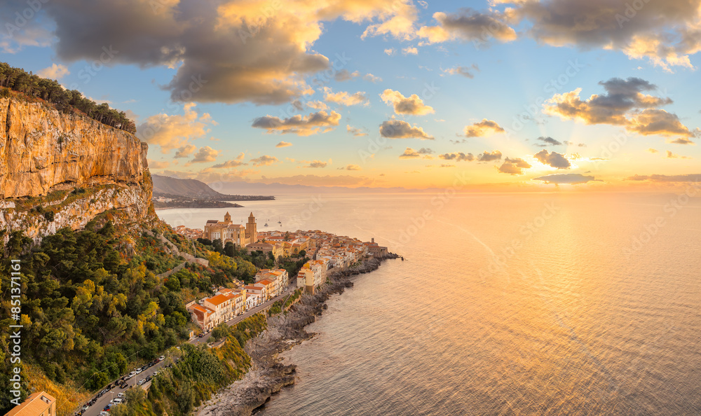 Aerial view showcasing its historic architecture, stunning coastline, and Mediterranean charm of Cefalu at sunset, Sicily.
