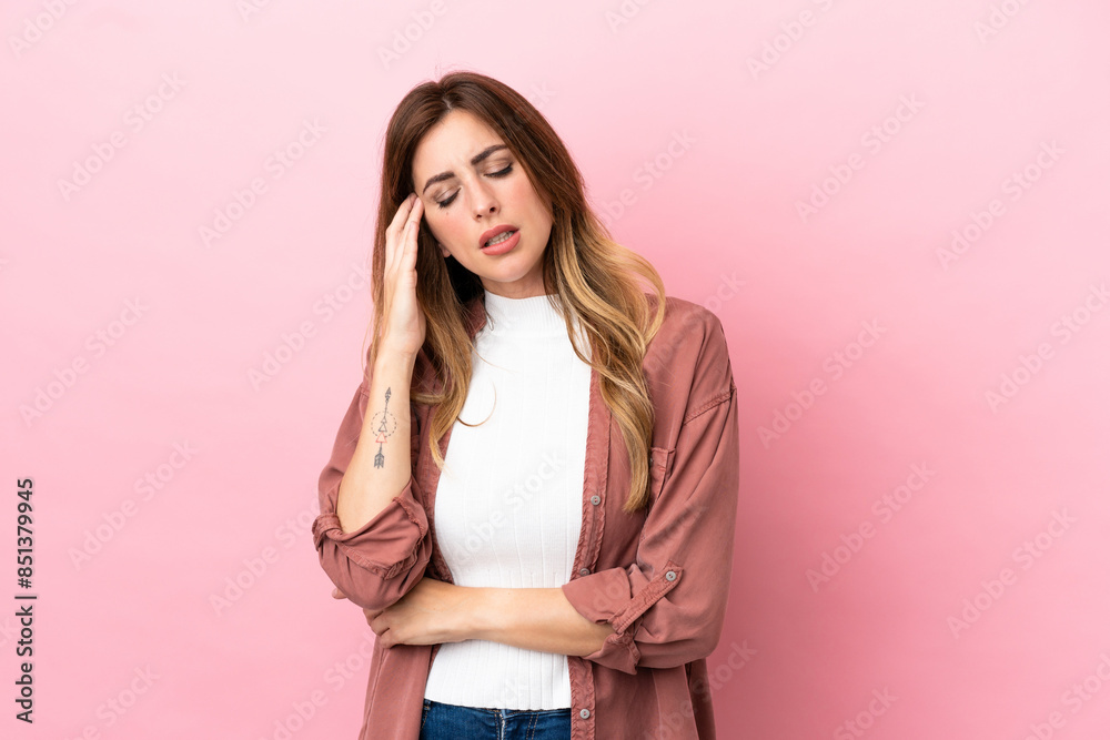 Caucasian woman isolated on pink background with headache Caucasian woman isolated on pink background with headache