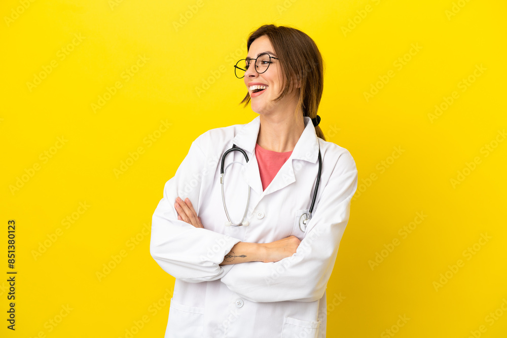 Doctor woman isolated on yellow background happy and smiling Doctor woman isolated on yellow background happy and smiling