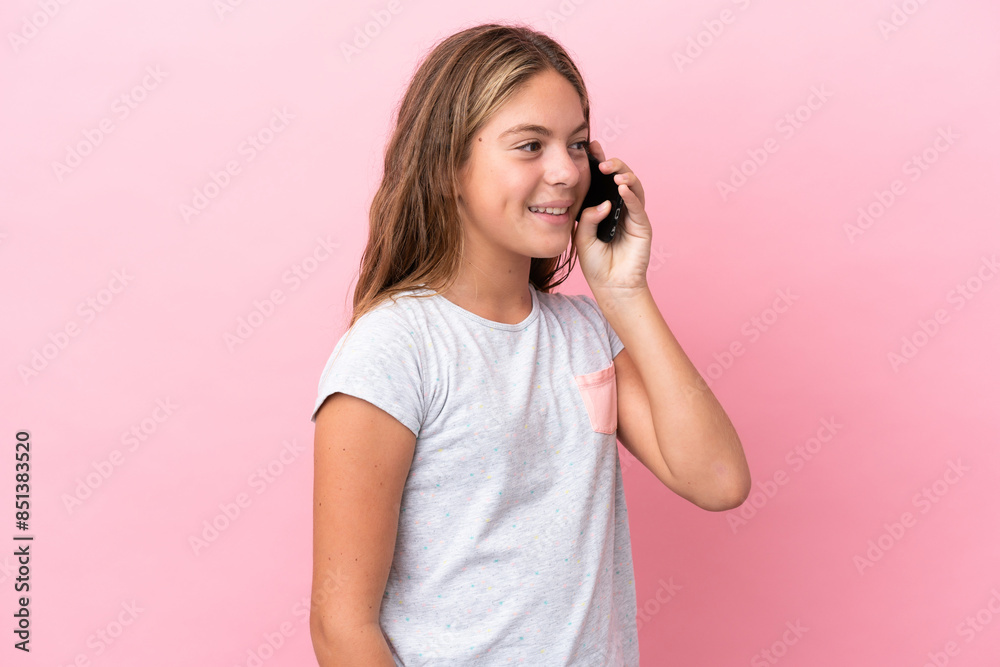Little caucasian girl isolated on pink background keeping a conversation with the mobile phone Little caucasian girl isolated on pink background keeping a conversation with the mobile phone