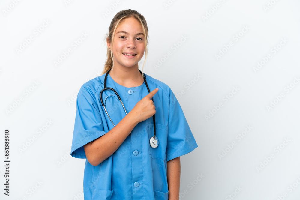 Little caucasian girl disguised as surgeon isolated on white background pointing to the side to present a product Little caucasian girl disguised as surgeon isolated on white background pointing to the side to present a product