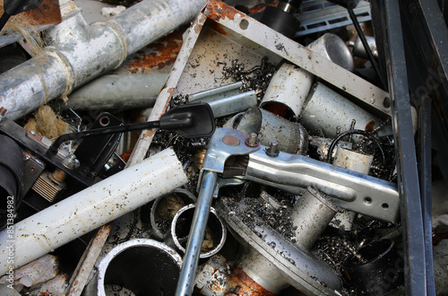 Scrap metal pieces, cut pipes and ferrous shavings in a scrap metal yard photo