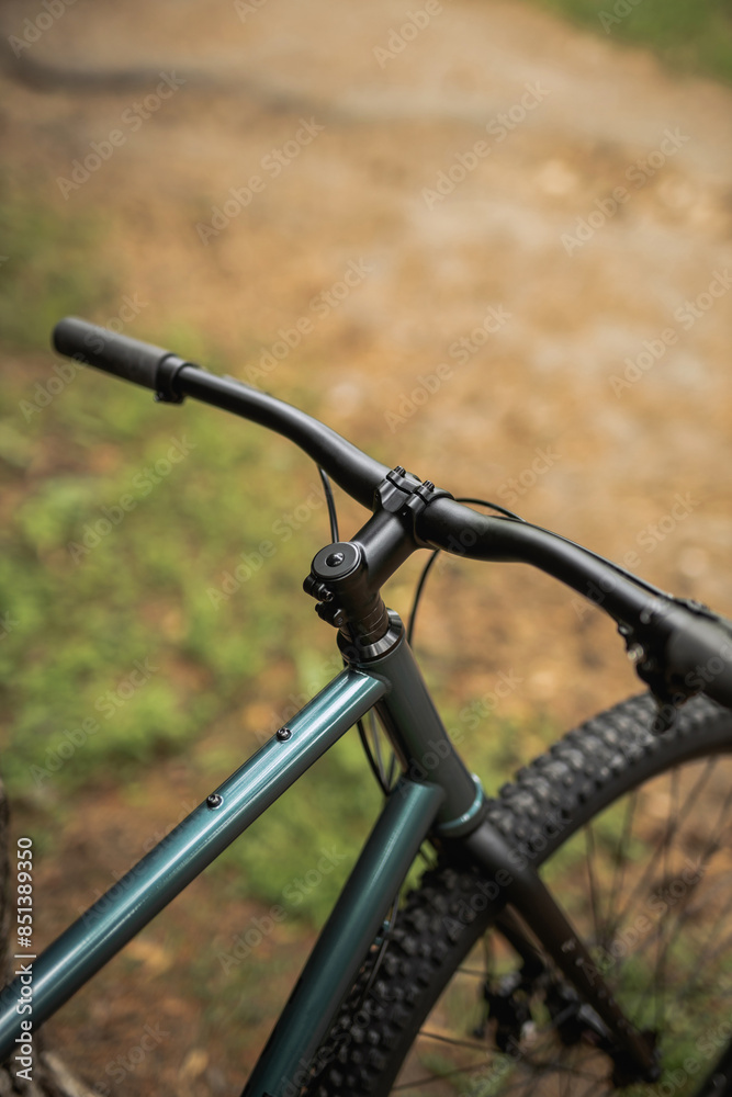 Obraz premium Photo of a bicycle in the park, top view of the handlebars