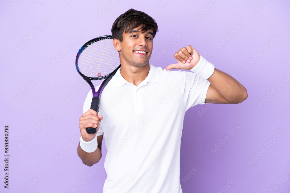 Handsome young tennis player man isolated on ocher background proud and self-satisfied Handsome young tennis player man isolated on ocher background proud and self-satisfied