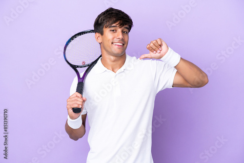 Handsome young tennis player man isolated on ocher background proud and self-satisfied © luismolinero