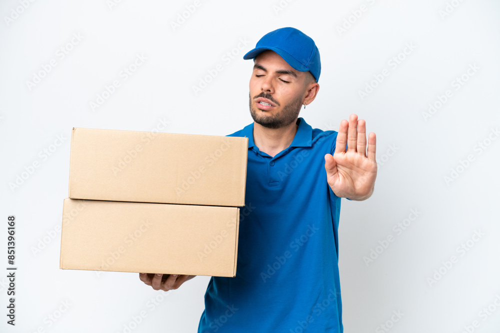 Delivery caucasian man isolated on white background making stop gesture and disappointed Delivery caucasian man isolated on white background making stop gesture and disappointed