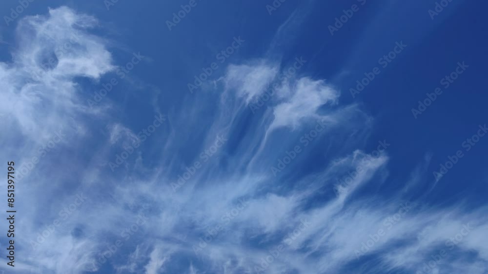 Curious cirrus clouds horizontally moving across the afternoon sky Curious cirrus clouds horizontally moving across the afternoon sky