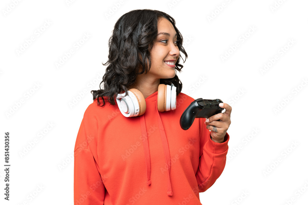 Young Argentinian woman playing with a video game controller over isolated background looking side Young Argentinian woman playing with a video game controller over isolated background looking side
