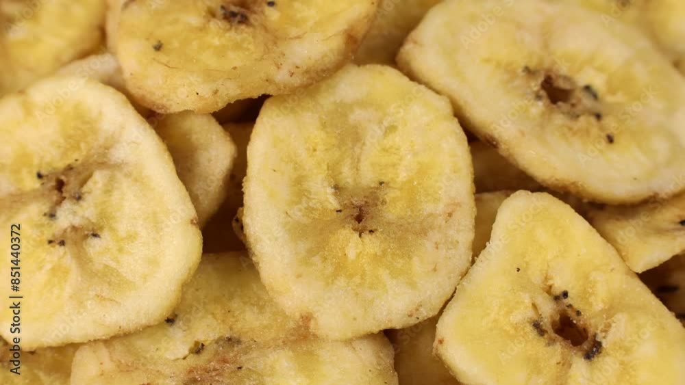 Sweet yellow dried banana chips circle rotation close up top view Sweet yellow dried banana chips circle rotation close up top view
