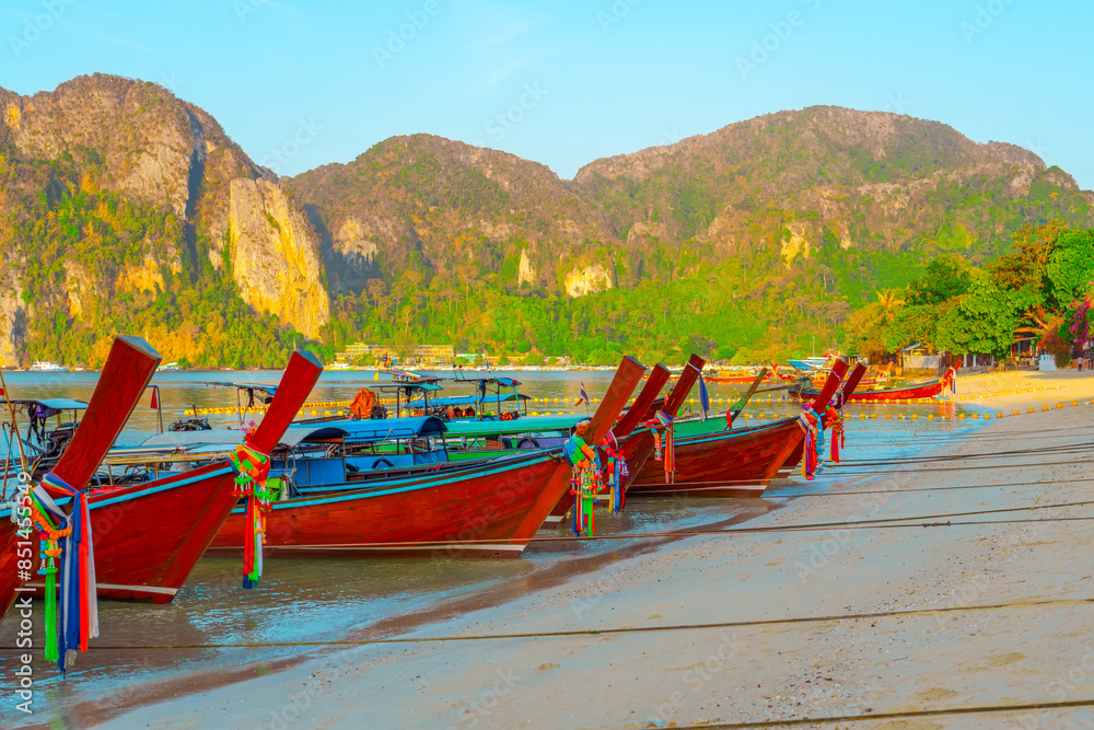 Fototapeta premium Longtail boats at the beautiful beach Thailand early morning at dawn beautiful sky clouds over sharks in the ocean