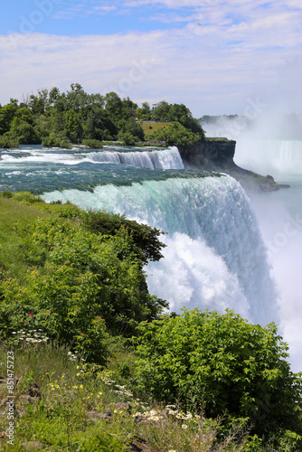 Niagara Falls waterfalls. American Falls,  Horseshoe Falls and Goat Island in the background. Niagara Falls, New York.
