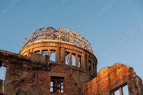 The last rays of the setting sun reflect upon the canopy of the Atomic Bomb dome in Hiroshima, Japan. photo