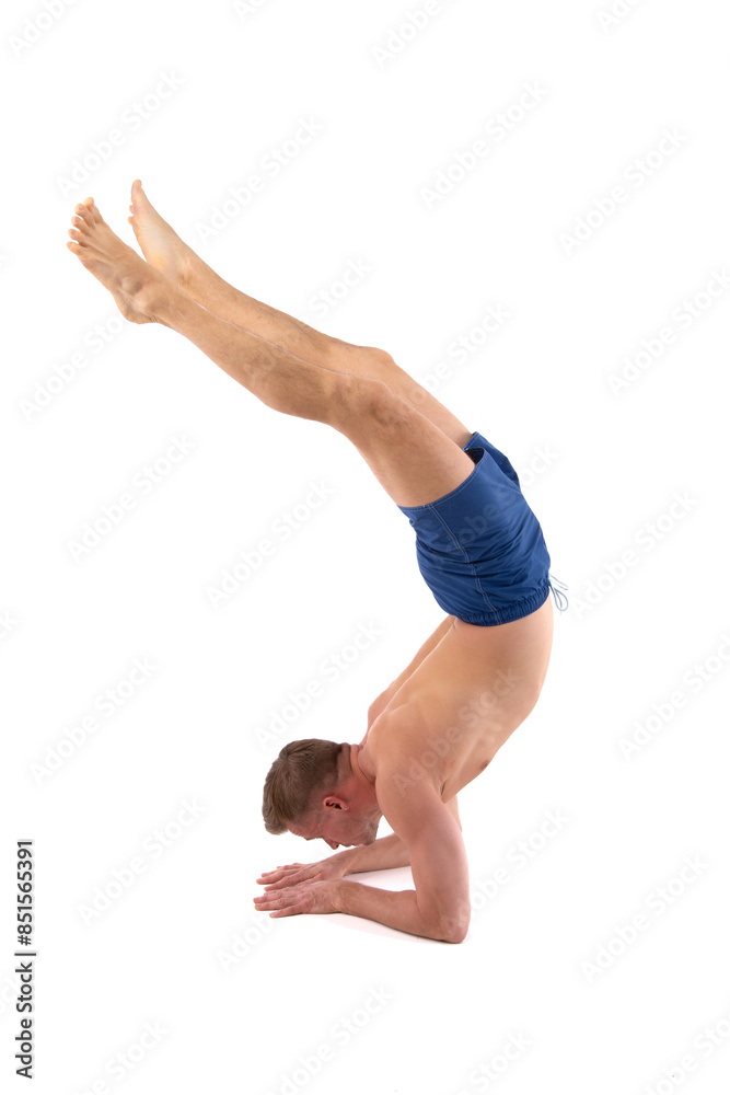 A young attractive man is doing yoga. White background.