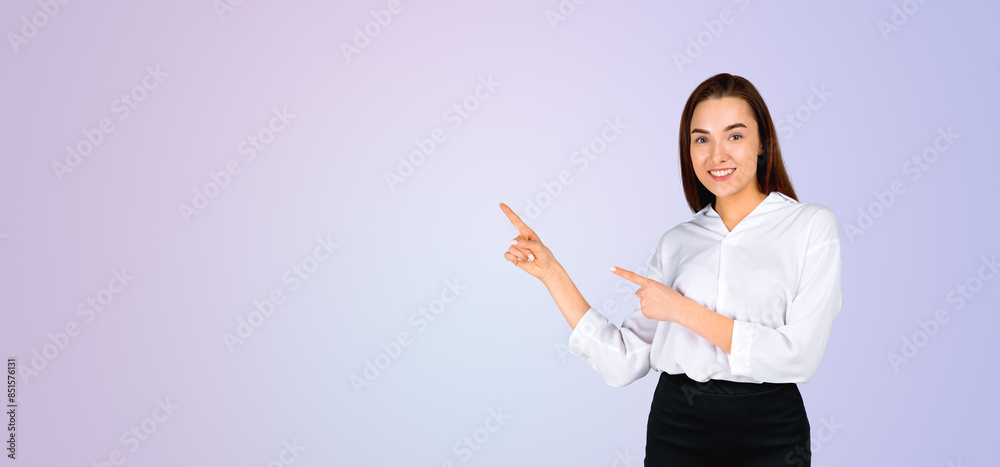 Woman in white shirt pointing to empty copy space, on pastel gra Woman in white shirt pointing to empty copy space, on pastel gra