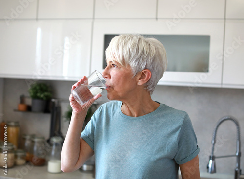 kitchen woman healthy morning mature breakfast active fitness water drink drinking glass thirsty fresh refreshment clean beverage diet home healthy eating senior adult healthy lifestyle photo