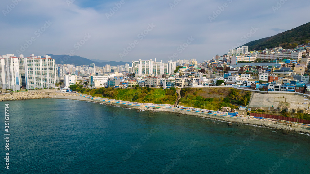 aerial view of Huinnyeoul Culture Village in Busan, Korea. The picture showcases a coastal village with a terraced landscape, colorful buildings, and a beautiful seafront. aerial view of Huinnyeoul Culture Village in Busan, Korea. The picture showcases a coastal village with a terraced landscape, colorful buildings, and a beautiful seafront.