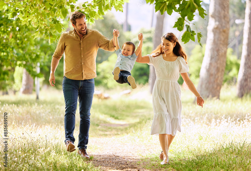 Obraz premium Smile, family and swinging child outdoor park together for bonding, love and support on summer vacation. Woman, man and kid play with care, trust and walking holding hands for freedom on holiday