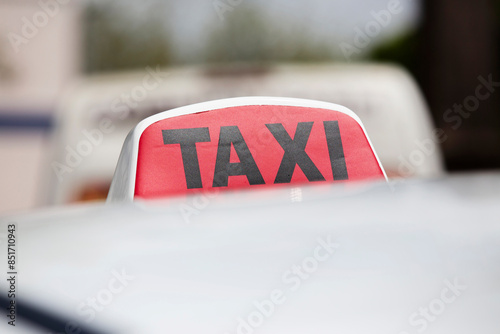 Red and black taxi sign on car close-up