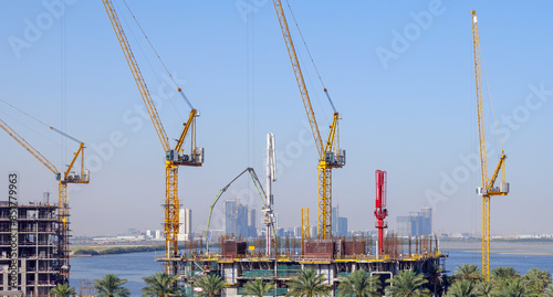 Photography residential buildings under construction with cranes at construction site
