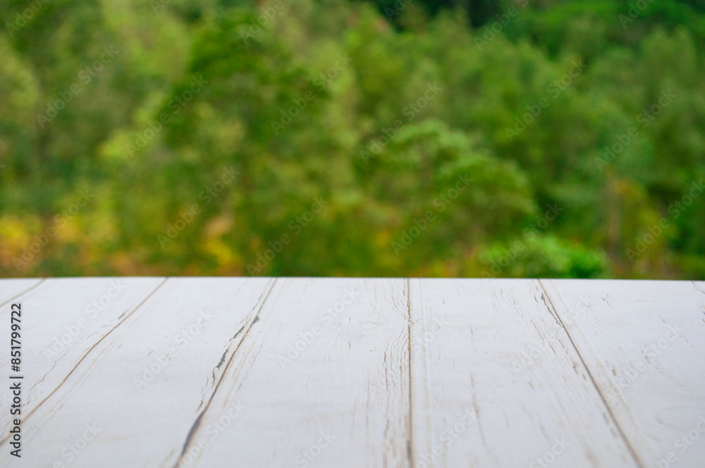 Empty wooden table in front of blurred nature background with customizable space for display or montage your products Empty wooden table in front of blurred nature background with customizable space for display or montage your products