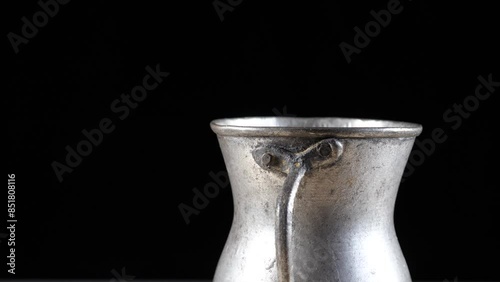 Old copper cup rotating 360 degrees on a turntable. 4k video capture
