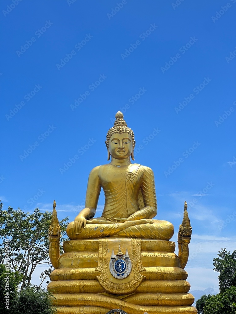 Big buddha statue at Phuket Thailand.Buddha statue closeup with selective focus and blur.Buddha statue with blue sky Big buddha statue at Phuket Thailand.Buddha statue closeup with selective focus and blur.Buddha statue with blue sky