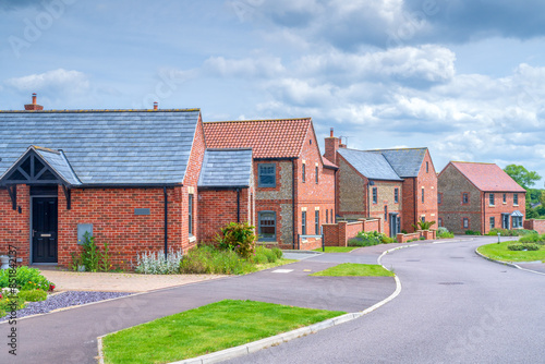 New part brick and part flint houses built in Norfolk, in the UK, example of modern homes built in Britain	