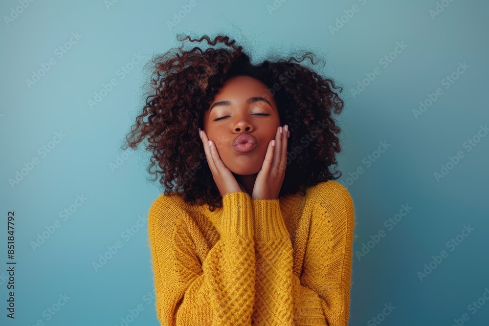 On blue, wall, or outdoor background, black woman blowing kiss for love, care, and flirting. Young girl, hand kisses, happy, romantic, lips-kissing face symbol On blue, wall, or outdoor background, black woman blowing kiss for love, care, and flirting. Young girl, hand kisses, happy, romantic, lips-kissing face symbol