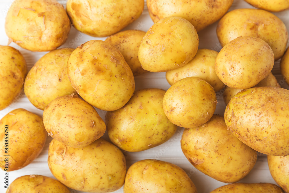 Young potatoes. Fresh potatoes on a wooden background.Harvesting collection. organic, freshly dug potatoes. Agricultural background. Vegan. Vegetables.Place for text.Copy space Young potatoes. Fresh potatoes on a wooden background.Harvesting collection. organic, freshly dug potatoes. Agricultural background. Vegan. Vegetables.Place for text.Copy space
