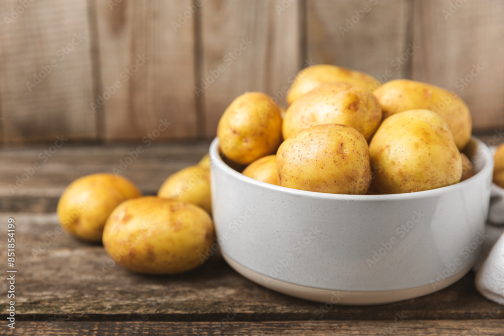 Young potatoes. Fresh potatoes on a wooden background.Harvesting collection. organic, freshly dug potatoes. Agricultural background. Vegan. Vegetables.Place for text.Copy space Young potatoes. Fresh potatoes on a wooden background.Harvesting collection. organic, freshly dug potatoes. Agricultural background. Vegan. Vegetables.Place for text.Copy space