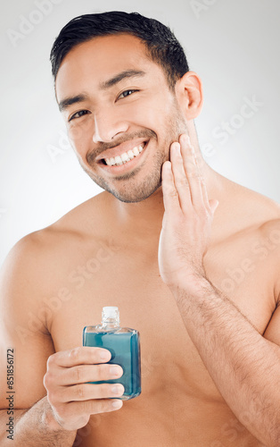 Tableau sur toile Portrait, man and bottle of aftershave with skincare for razor burn and hair removal in studio
