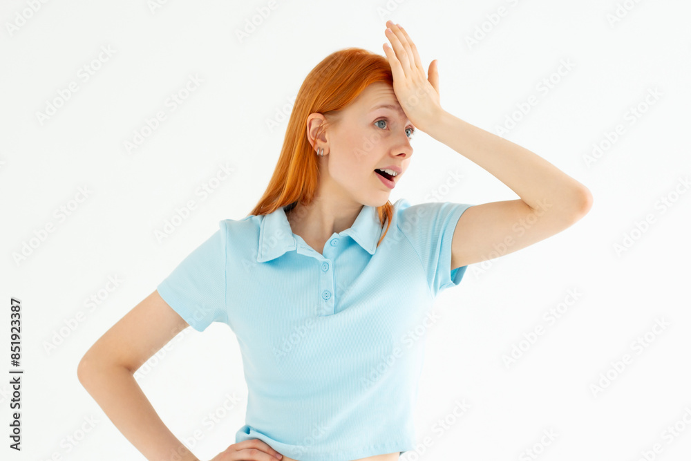 Fototapeta premium Gosh why me. Portrait of unhappy displeased and annoyed young arrogant woman in blue top facepalming with irritation breathing out with opened mouth and rolling eyes from annoyance and exhaust