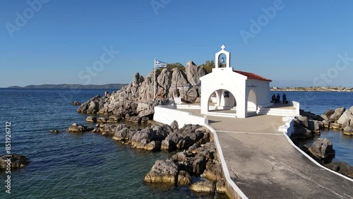 Little church of Agios Isidoros in the sea over the rocks, Chios island, Greece. photo